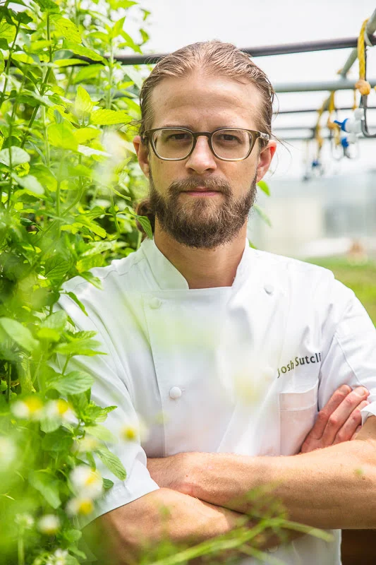 Josh Sutcliff photographed among growing plants