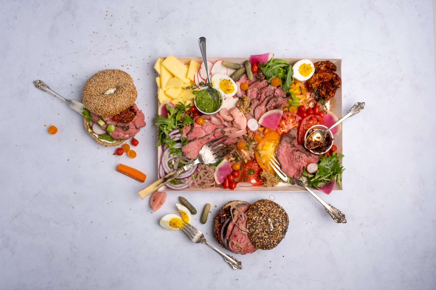 Bagels, spreads, and a catering platter.