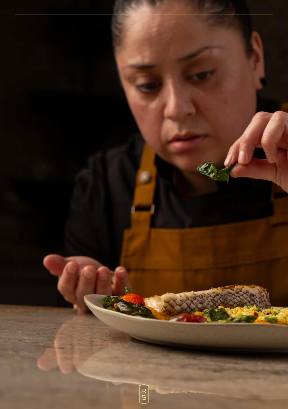 Booklet page 10: Rosie adding herbs to a finished dish