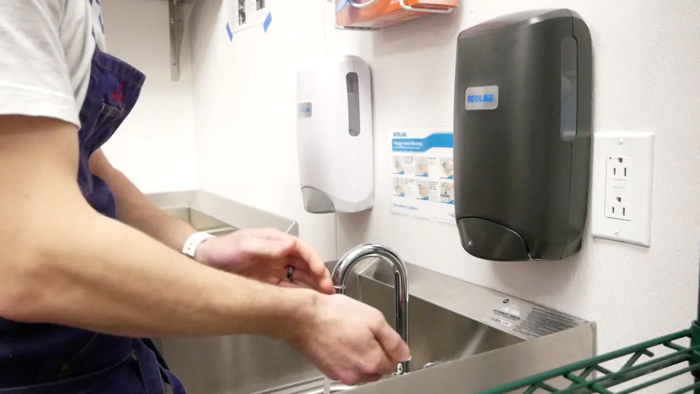 Handwashing demonstration in the Herald Cafe kitchen.