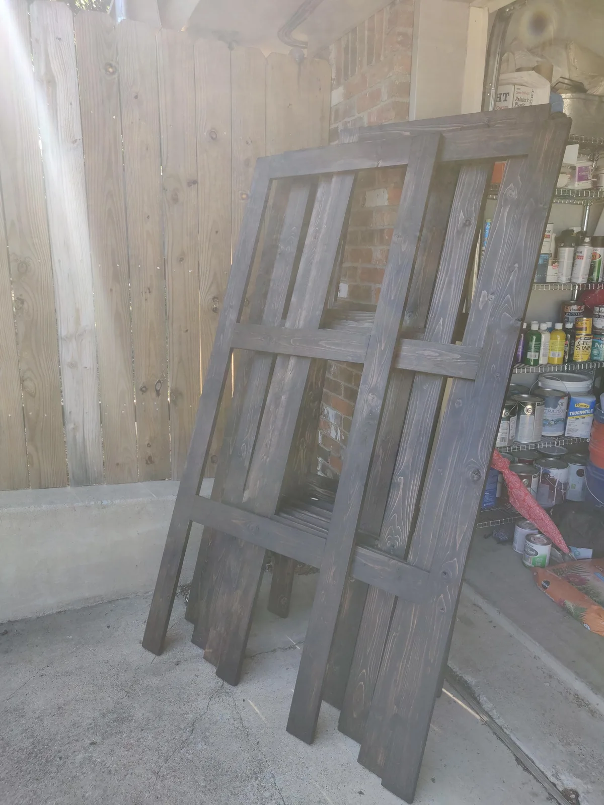 Stained wooden frames drying in the garage.